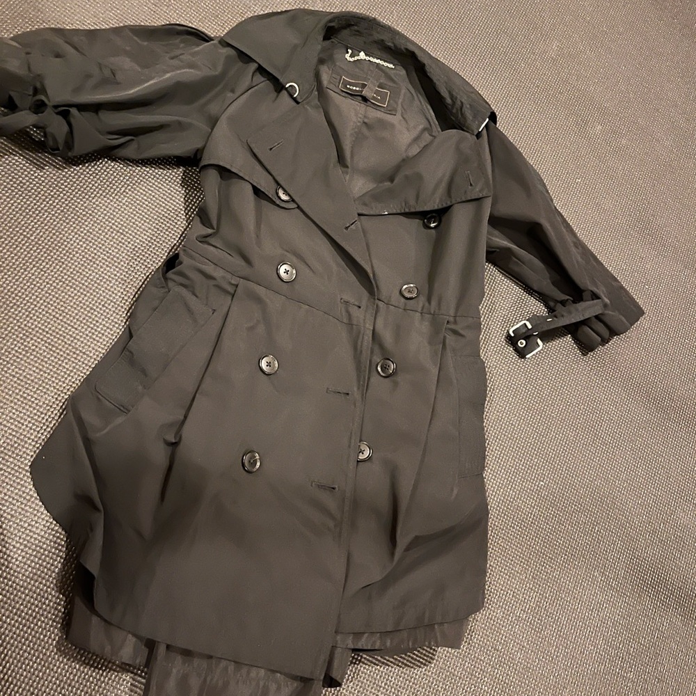 Black BCBG trench, half cuff at elbow.